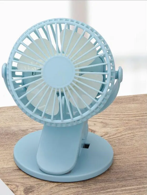 Small white USB rechargeable clip fan with plastic blades attached to desk edge