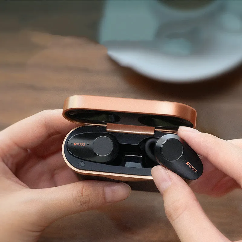 Black wireless Bluetooth headphones with charging stand showing true wireless stereo design