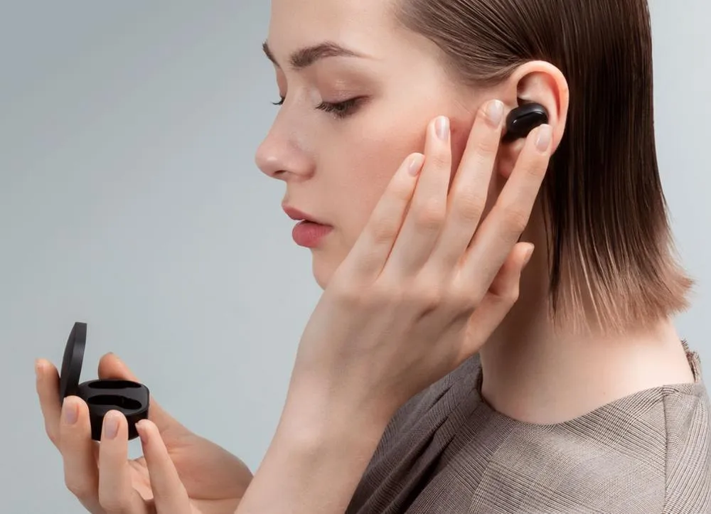 Black Redmi AirDots true wireless Bluetooth earbuds with a charging case.