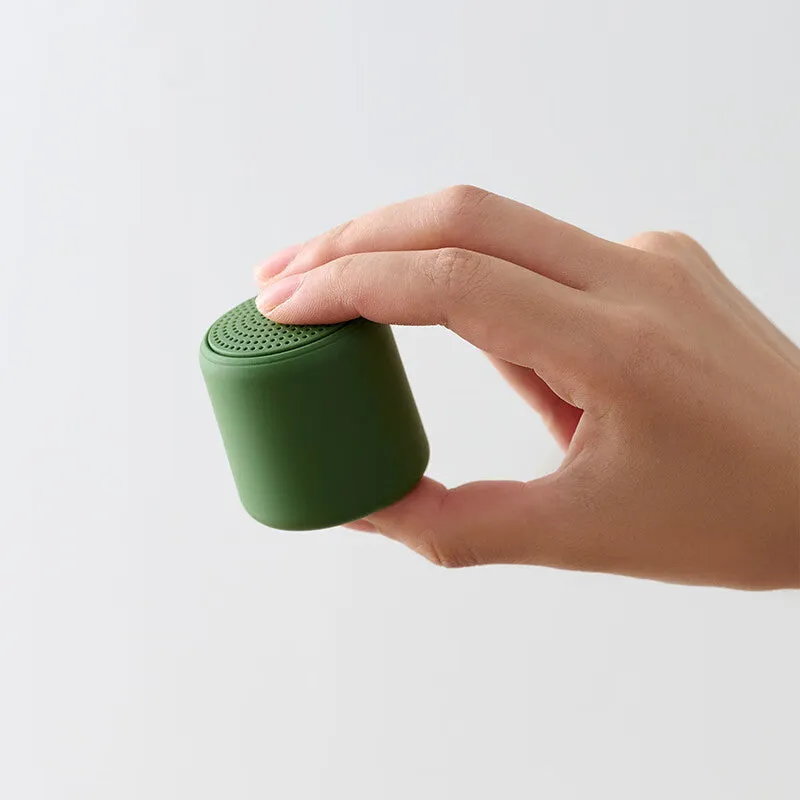 Mini portable wireless Bluetooth speaker in black with rounded edges and fabric grille, 45x48mm size
