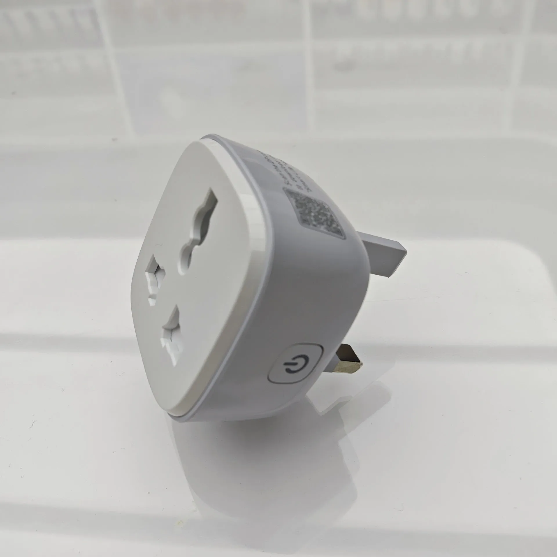 White smart WiFi socket with EU plug standard, timer and overload protection functions on white background