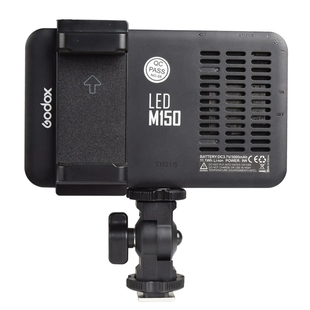 Slim silver Shenniu M150 LED video light with bracket on a mobile phone.