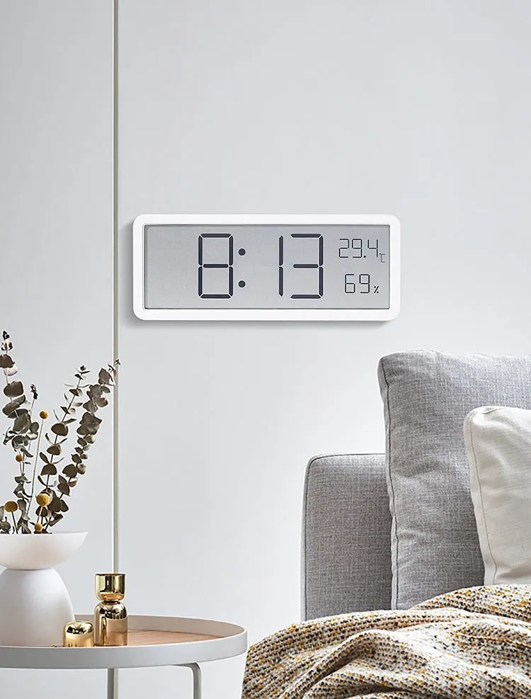 Simple large screen temperature and humidity clock with plastic shell in white Nordic style on a desk