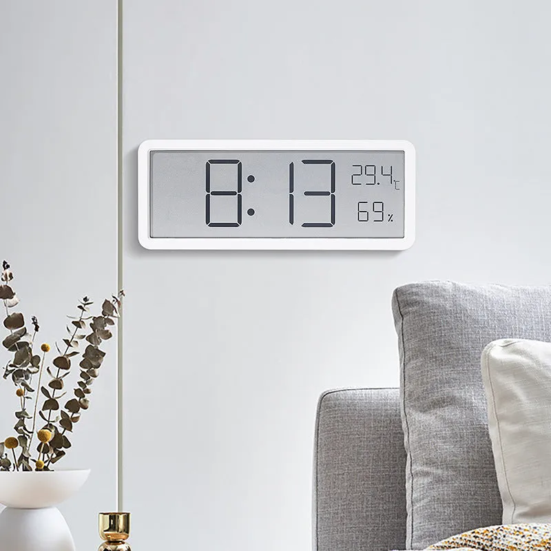 Simple large screen temperature and humidity clock with plastic shell in white Nordic style on a desk