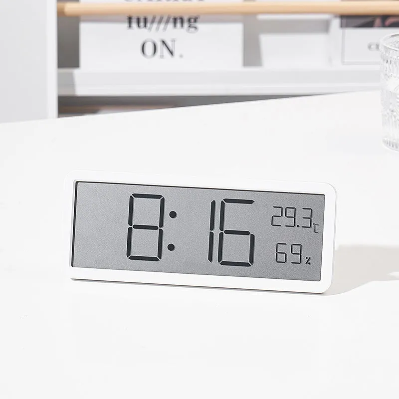 Simple large screen temperature and humidity clock with plastic shell in white Nordic style on a desk