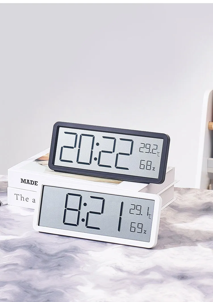 Simple large screen temperature and humidity clock with plastic shell in white Nordic style on a desk