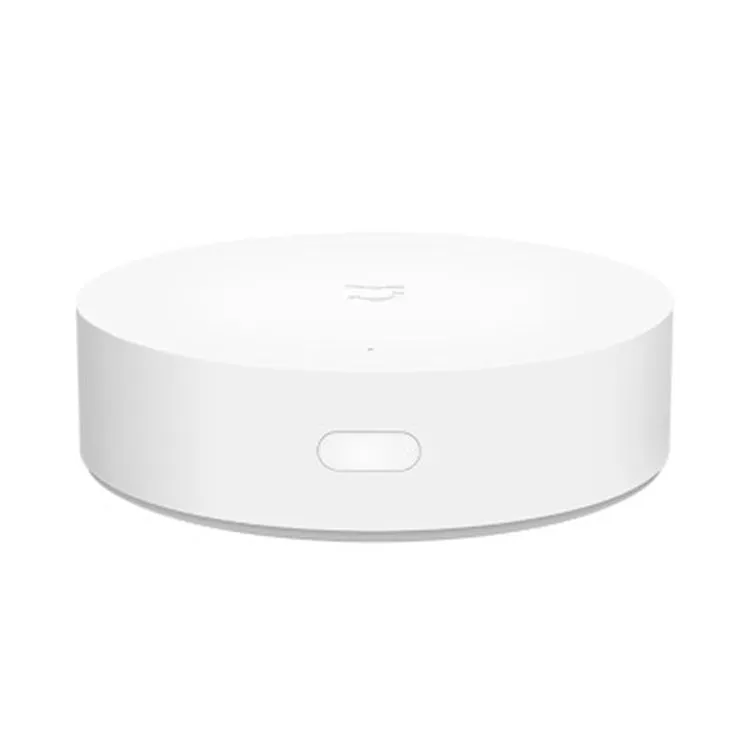 White circular smart home gateway wall switch with UK plug for remote device control