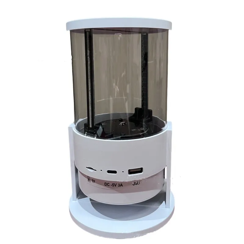 White 360-degree 3D holographic fan Bluetooth speaker with cylindrical screen on a desk