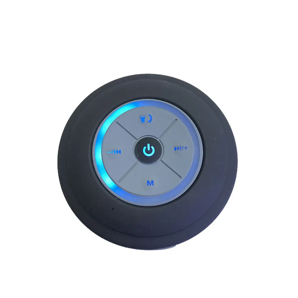 Waterproof suction cup Bluetooth speaker in black attached to a tiled wall