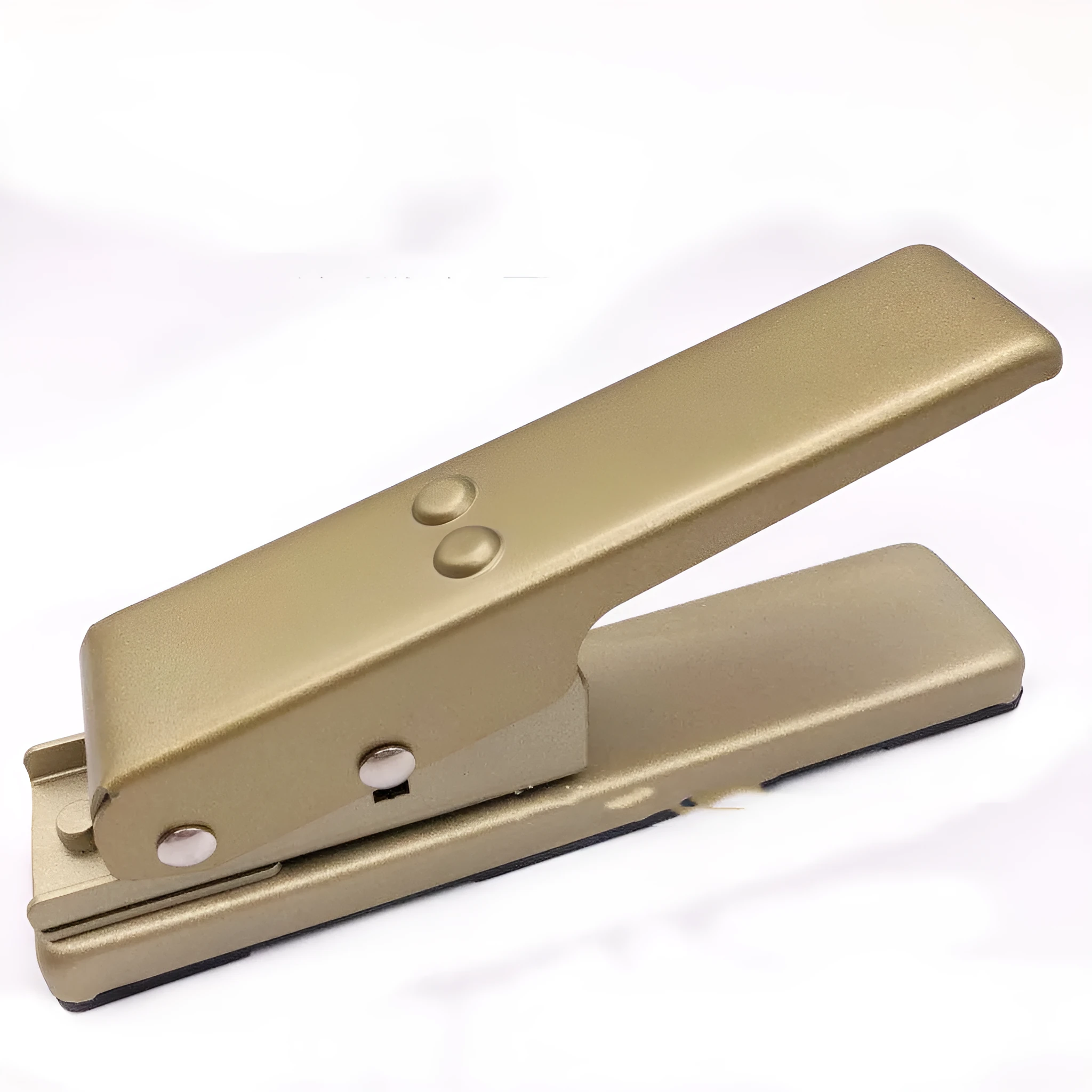 Gold metal guitar pick card cutter on a flat surface showing the punch head and metallic finish