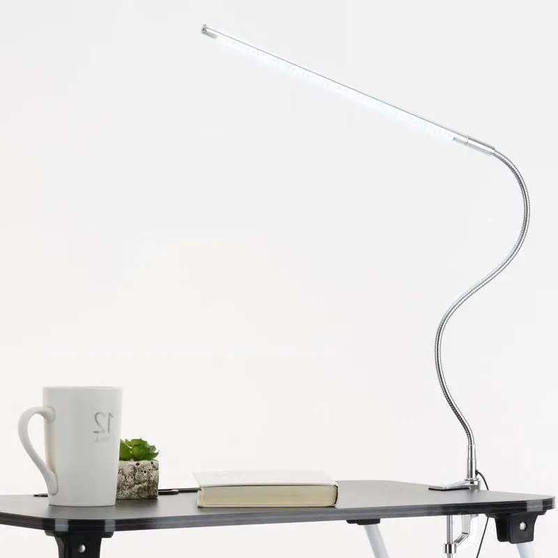 Silver aluminium alloy USB LED nail lamp with long arm and clip-on base, lit with bright white light.