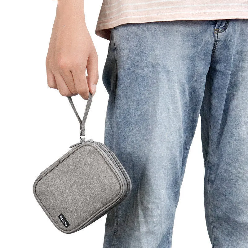 Grey and black Oxford cloth protective storage bags for 2.5-inch portable hard drives on a table.