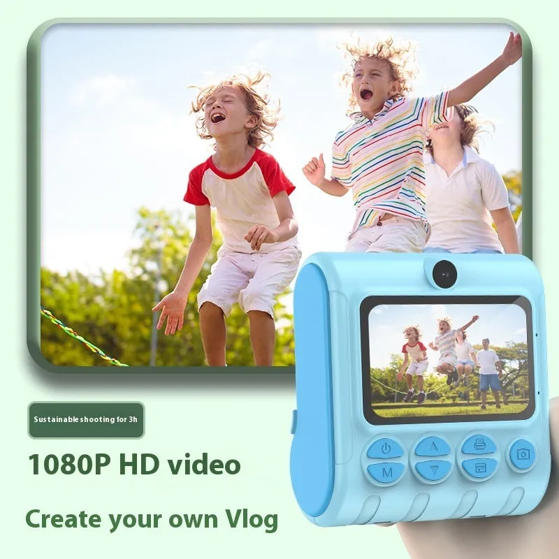 Children's instant printing camera with dual HD cameras in pink colour, showing included lanyard and printing paper