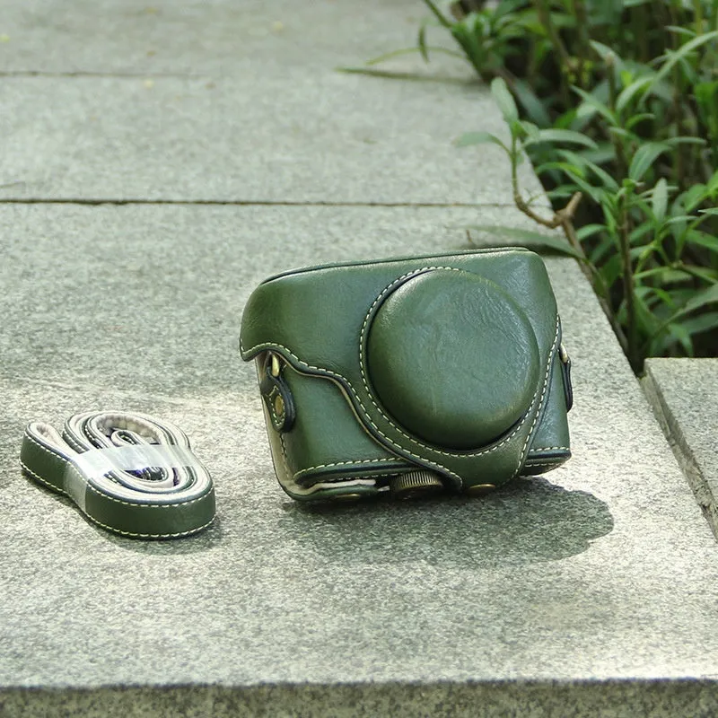 Black imitation leather portable card camera bag with crossbody strap on a solid background