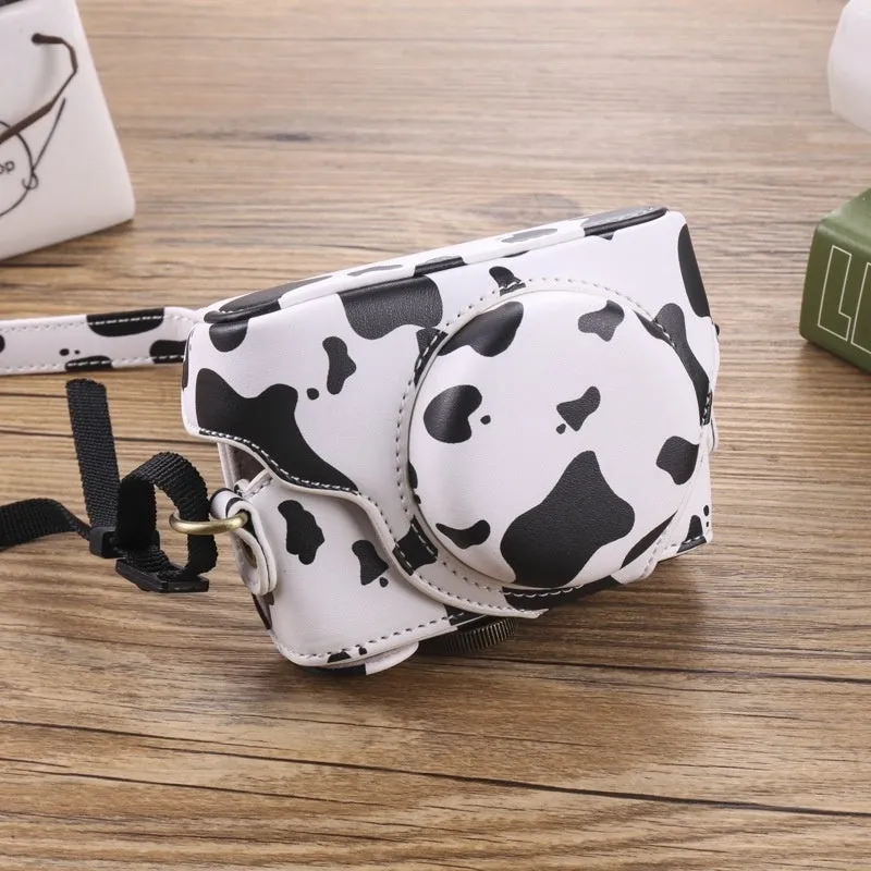 Black imitation leather portable card camera bag with crossbody strap on a solid background