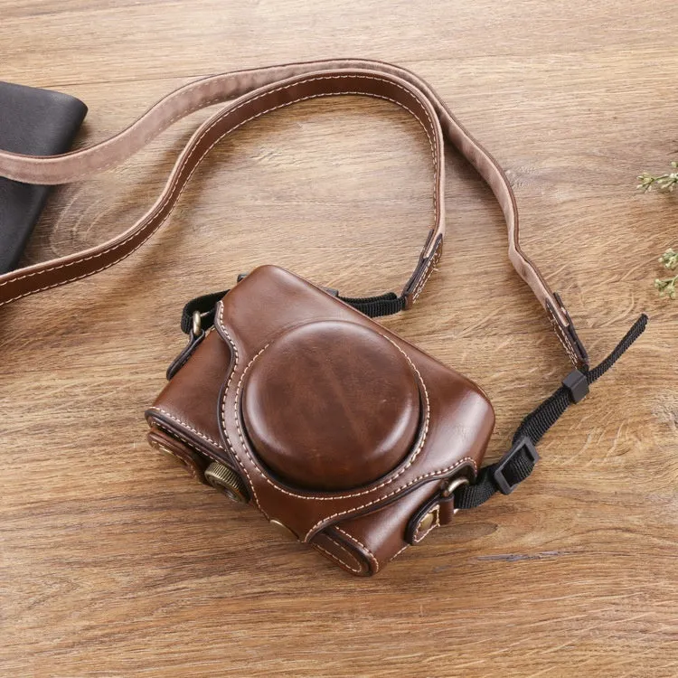 Black imitation leather portable card camera bag with crossbody strap on a solid background