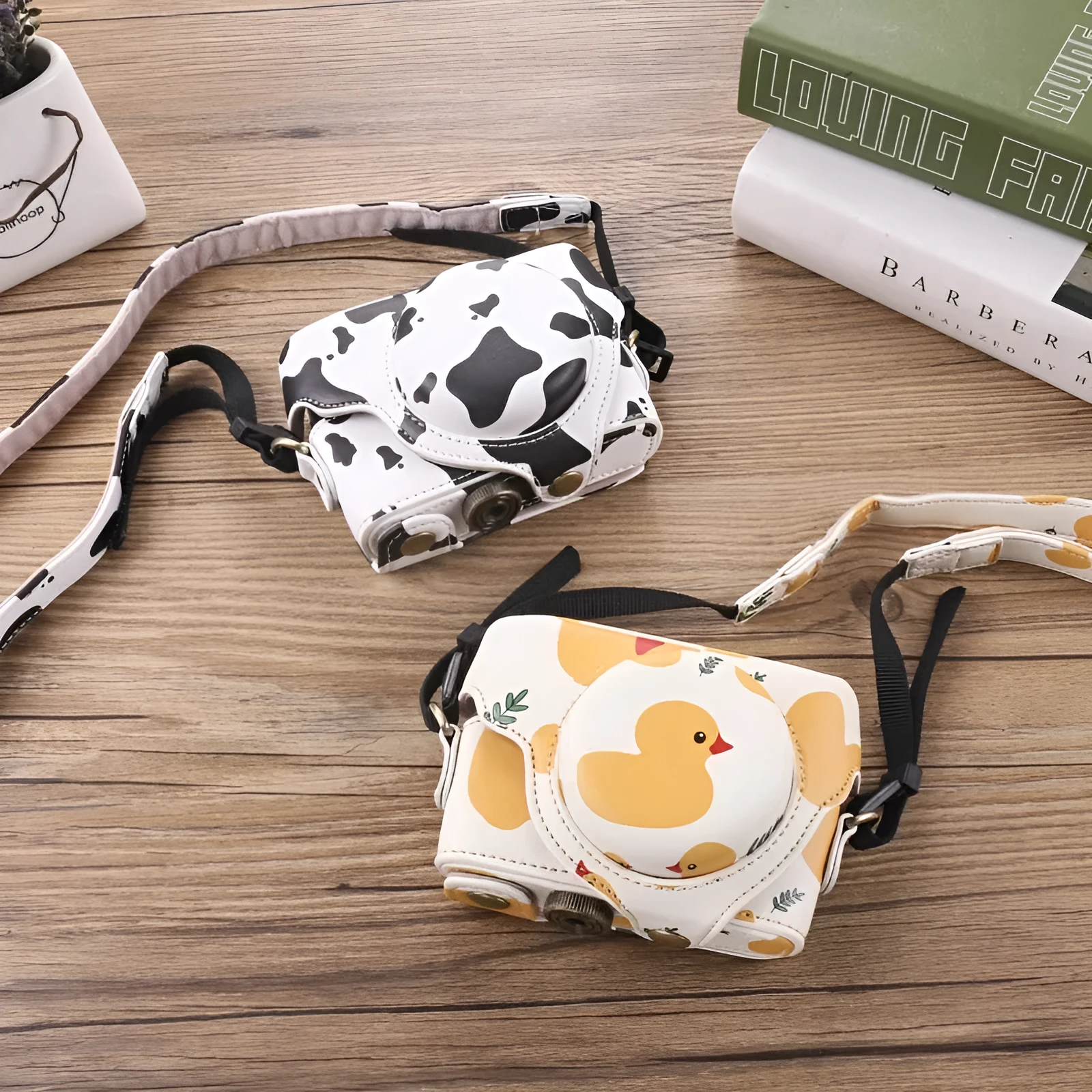Black imitation leather portable card camera bag with crossbody strap on a solid background