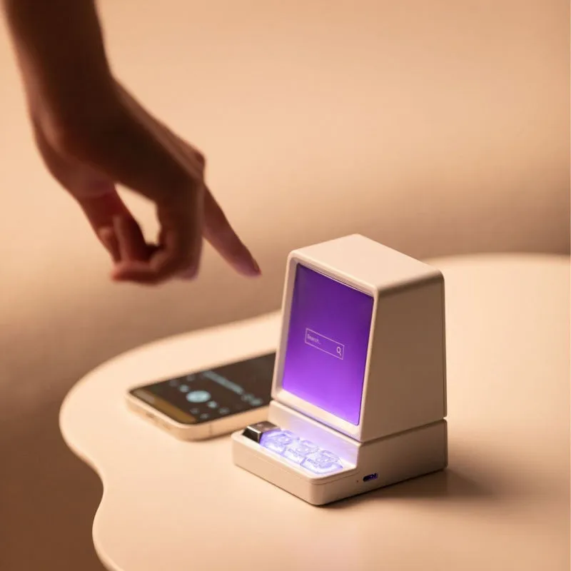 Portable classic computer-shaped Bluetooth speaker in light gray with lighting and voice prompt on a desktop