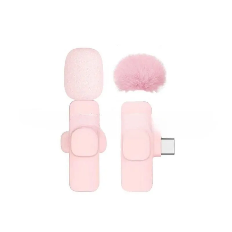Pink K1K9 one-drag wireless microphone with receiver, charging cable, and hairball windshield on a table
