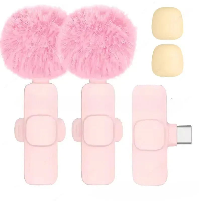 Pink K1K9 one-drag wireless microphone with receiver, charging cable, and hairball windshield on a table