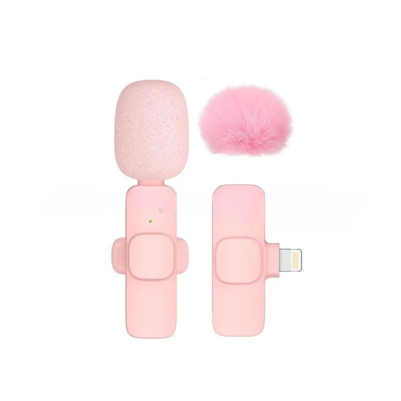 Pink K1K9 one-drag wireless microphone with receiver, charging cable, and hairball windshield on a table