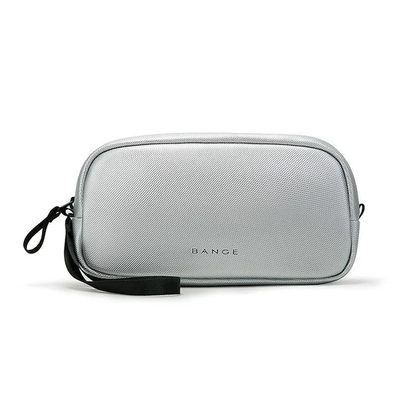 Large capacity digital accessories storage bag in black with sewing line detailing on a plain background