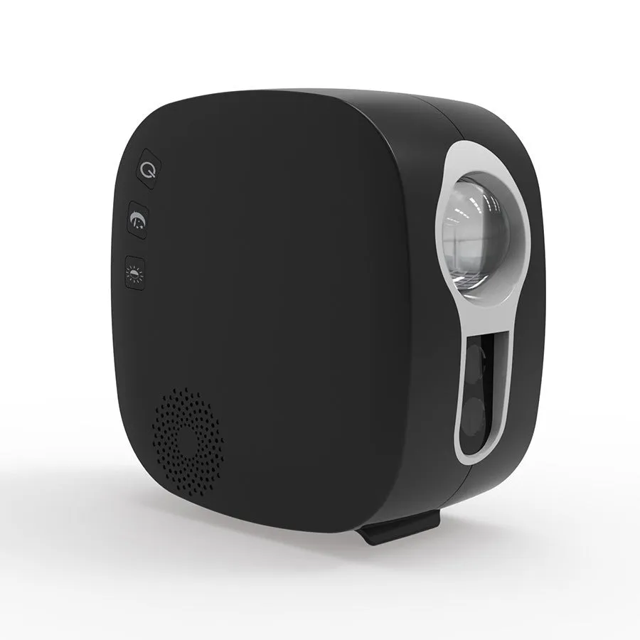 Black cube laser star projector showing nebula and moon display on a wall.