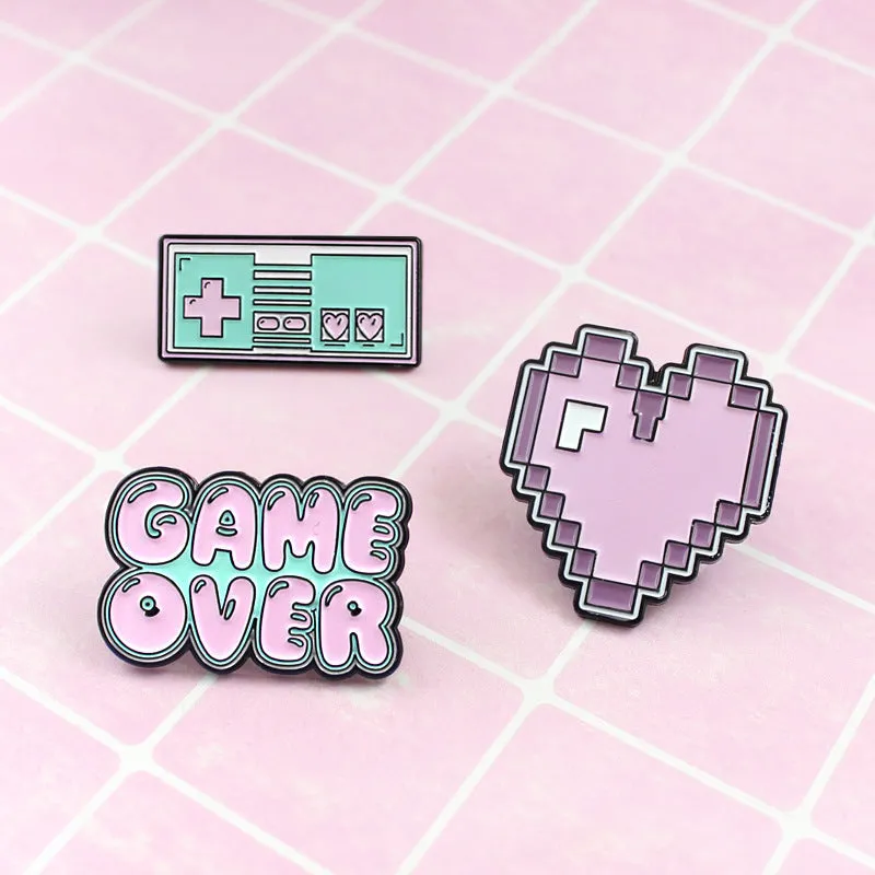 Stereo game console metal alloy badge with pin back, shown in available colours on a backpack strap