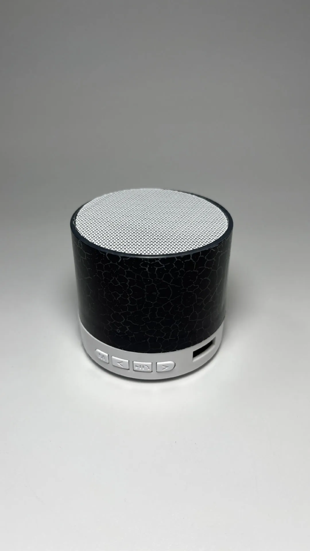 A9 Mini Cracked Bluetooth Speaker in blue with LED lights on a table