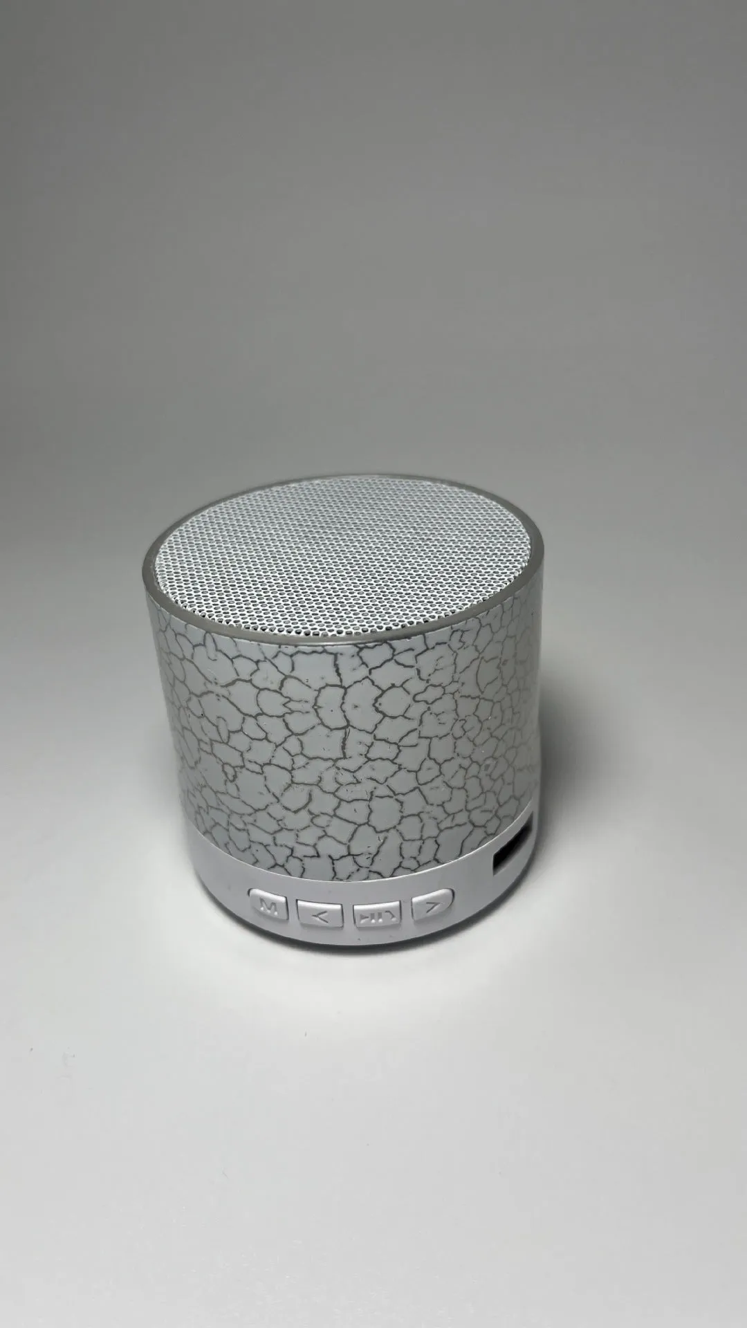 A9 Mini Cracked Bluetooth Speaker in blue with LED lights on a table