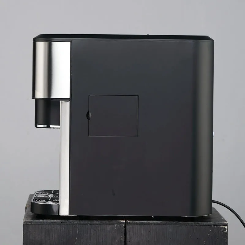 Black desktop ice maker machine with stainless steel interior on a kitchen countertop