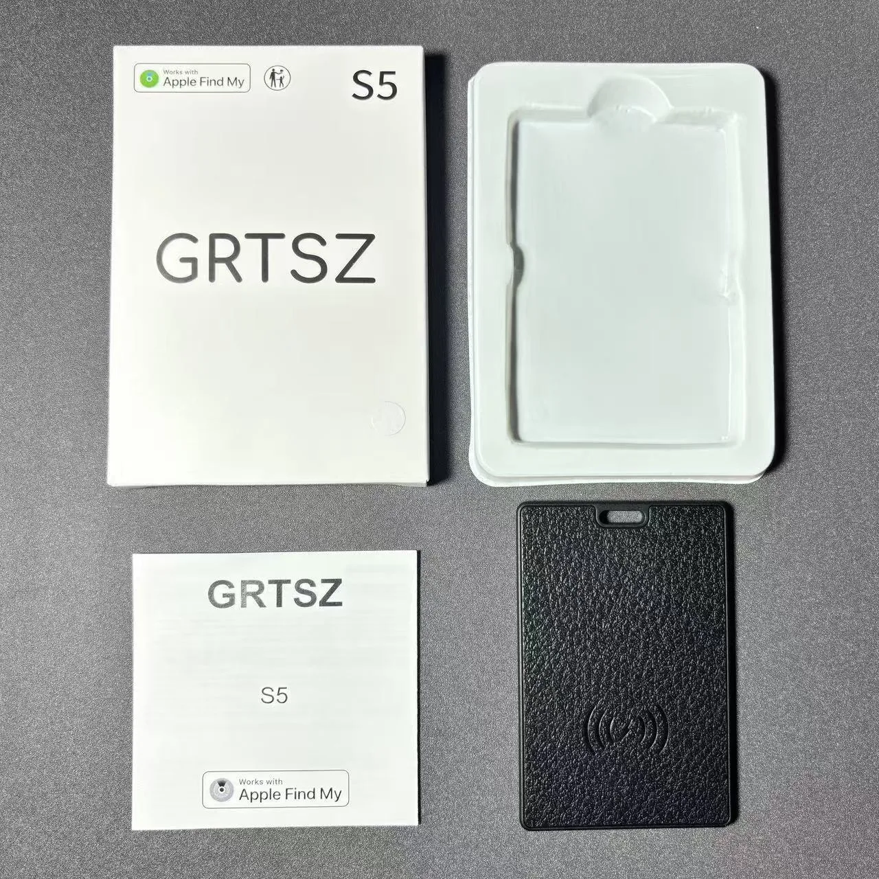 iOS card tracker in black with wireless charger, showing compact 80x53x3.8mm size against a keychain