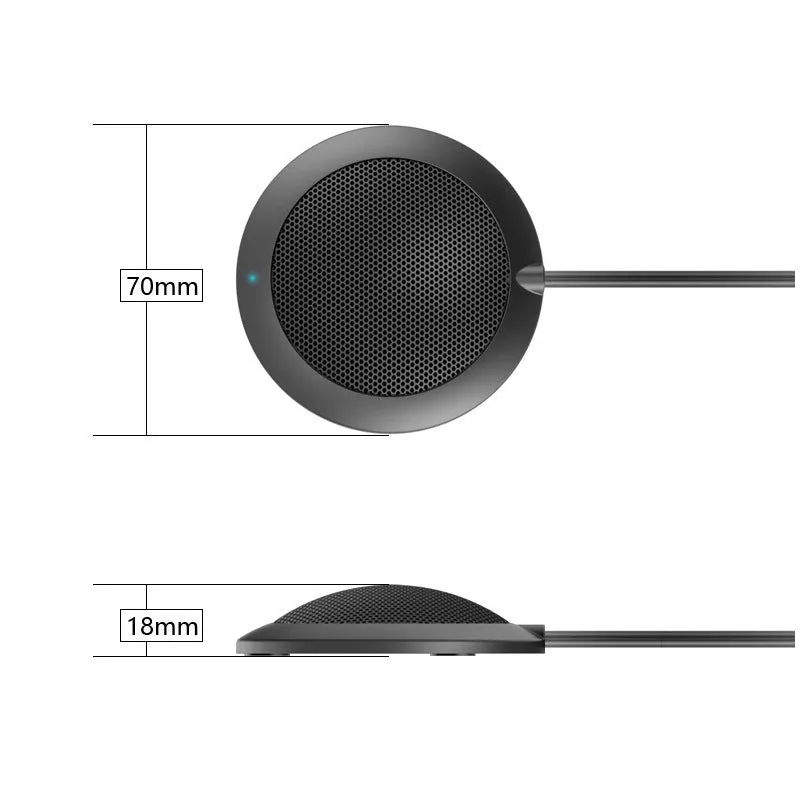 Black USB desktop microphone with metal mesh cover on a desk next to a laptop