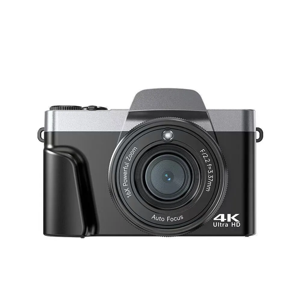 Black flip mirrorless digital camera resting on a cloth surface, showing its compact body and flip screen