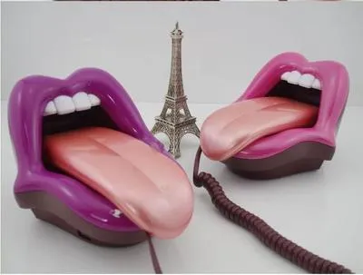 Red lip novelty telephone with LED indicator on a desk