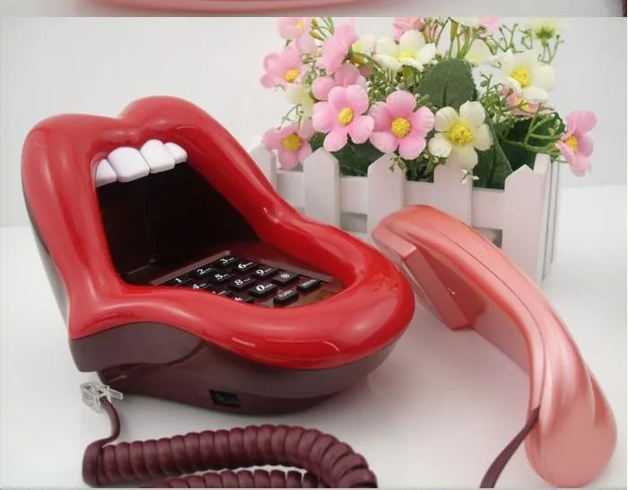 Red lip novelty telephone with LED indicator on a desk
