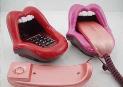 Red lip novelty telephone with LED indicator on a desk