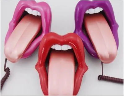 Red lip novelty telephone with LED indicator on a desk
