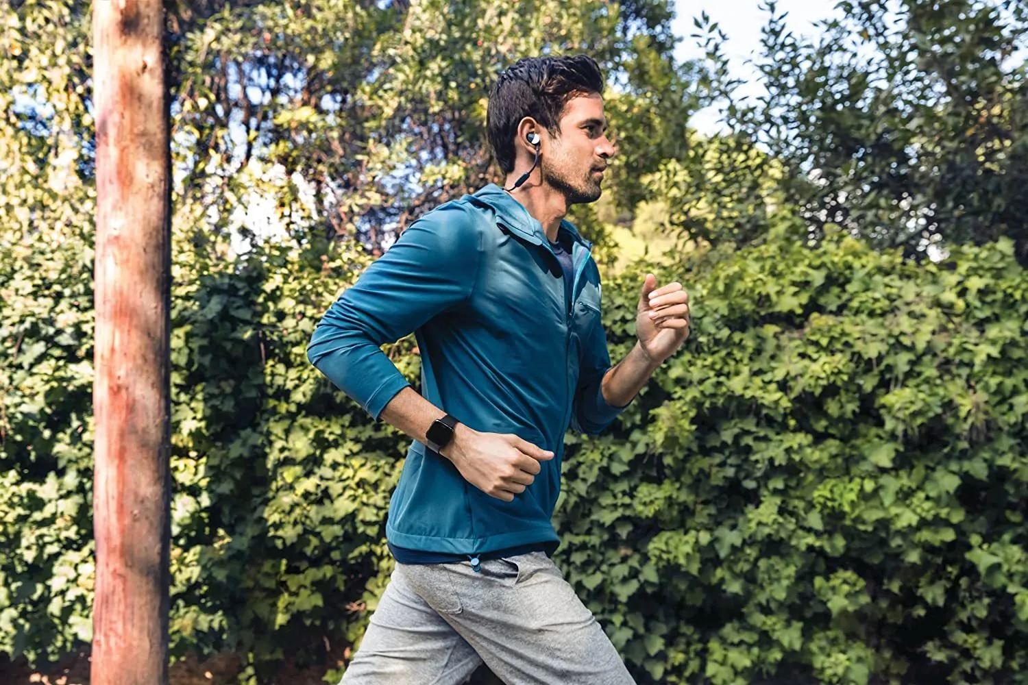 Black smart watch with heart rate monitoring on silicone wristband showing 1.4-inch screen