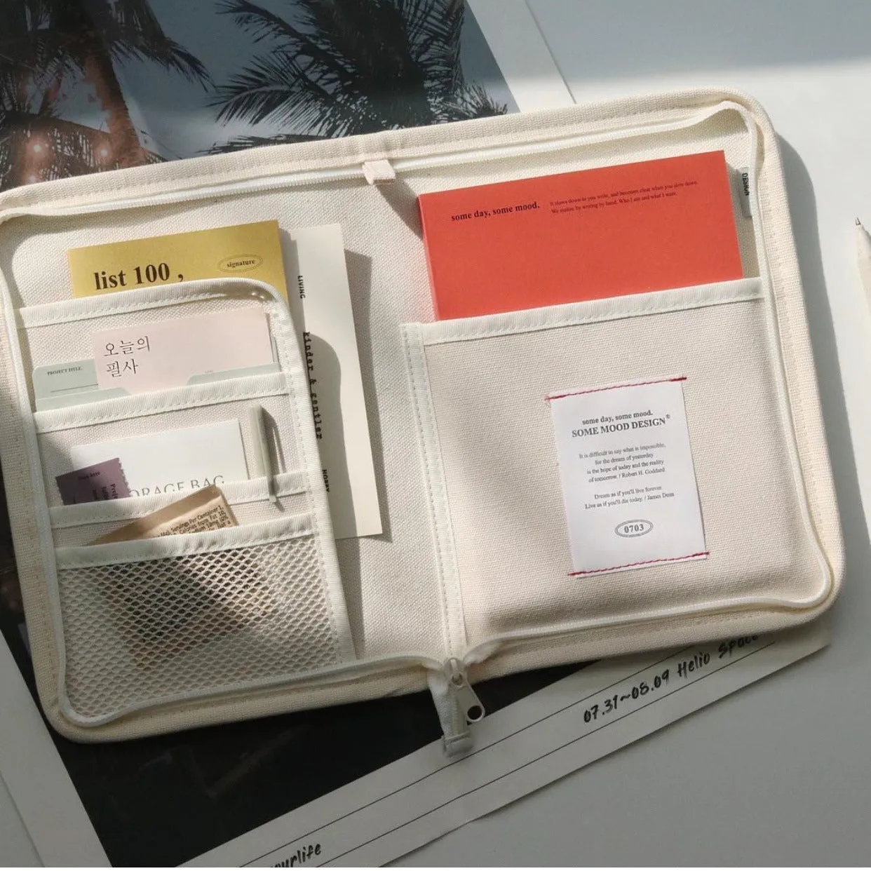 Canvas tablet storage bag with zipper opening and soft handle designed for 12-inch devices, shown in black and white colours