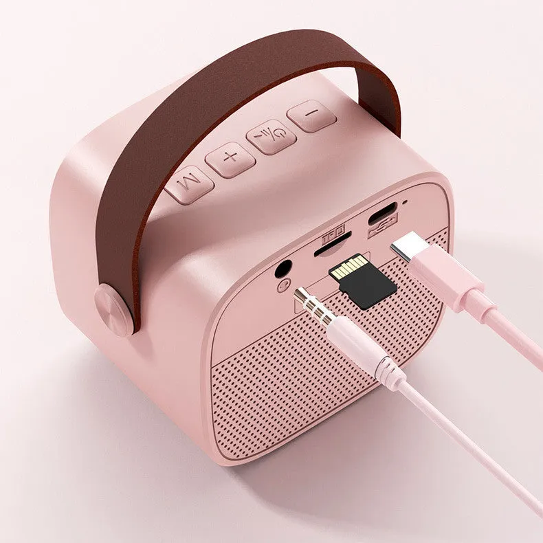 Compact blue, pink or white portable Bluetooth speaker with built-in microphone on a surface.