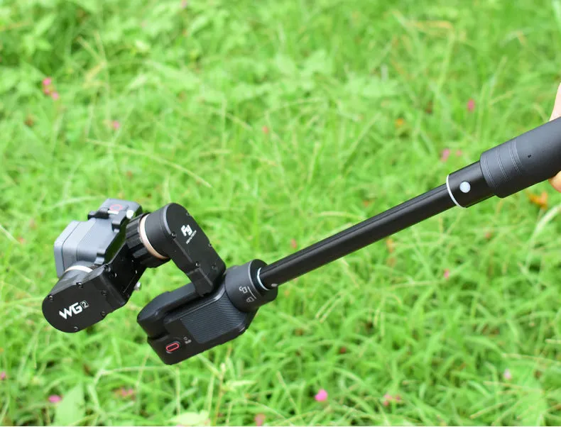 Black retractable aluminium selfie stick with phone clamp, extended to full length.