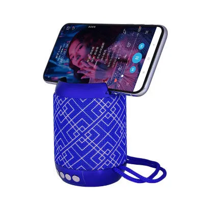 Mini wireless Bluetooth speaker with fabric covering in blue, showing button controls and compact size
