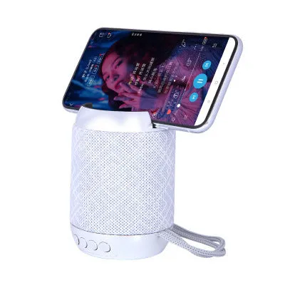 Mini wireless Bluetooth speaker with fabric covering in blue, showing button controls and compact size