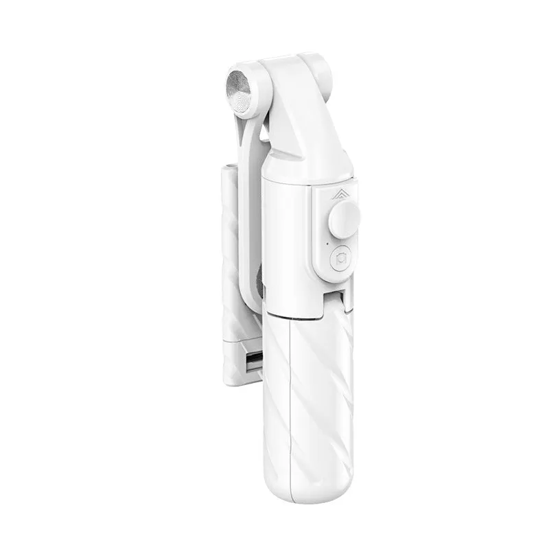 V03 black mini selfie stick Bluetooth tripod extended to 70 cm on a tabletop, phone attached and remote control visible