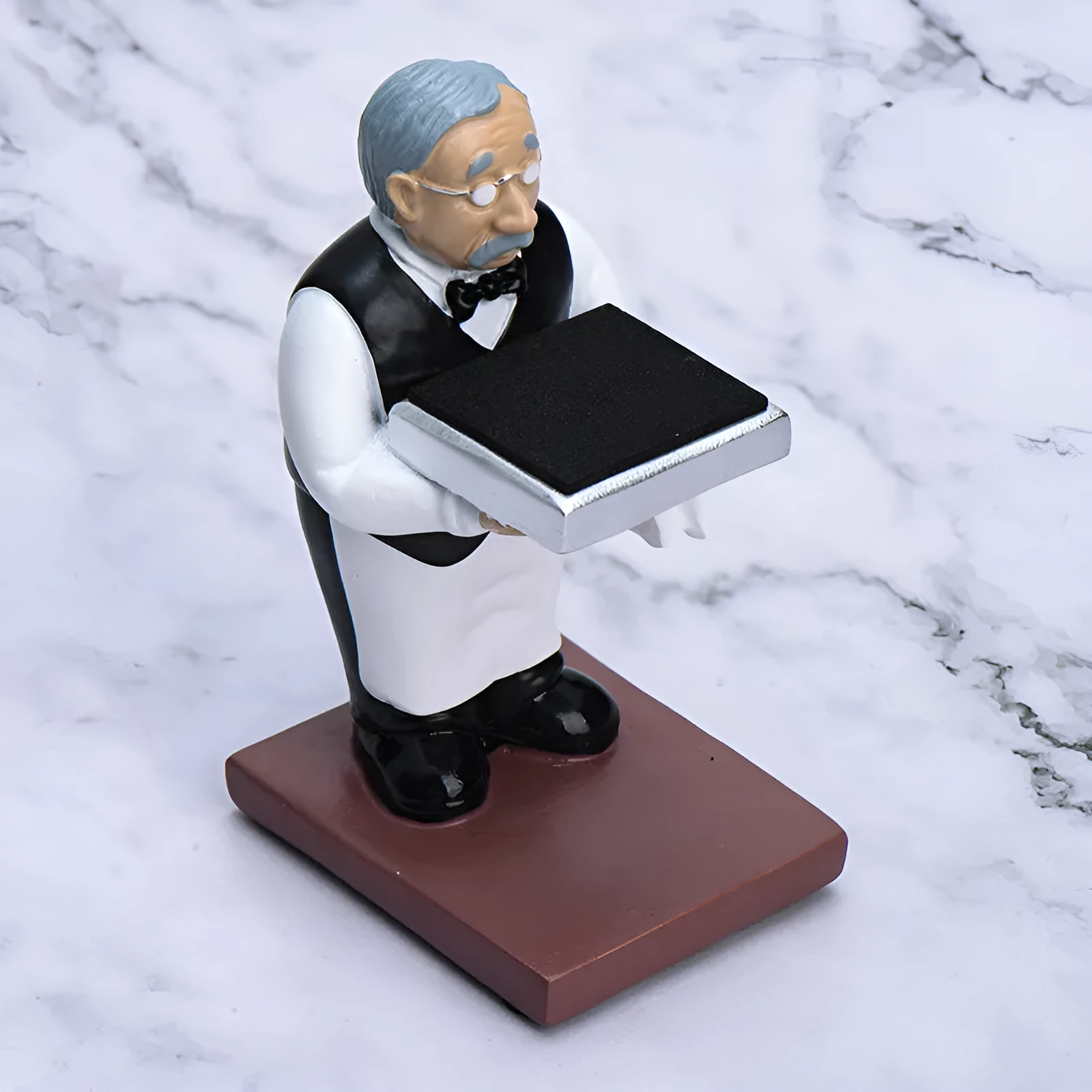Resin watch stand display rack with creative decoration ornament in style A, holding a watch