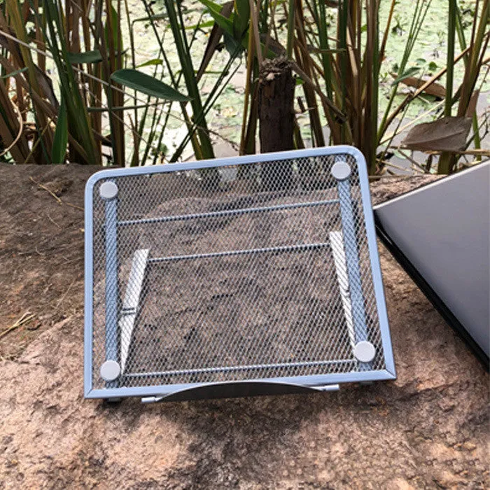Foldable laptop stand in black iron with semi-circular baffle and non-slip pads on a desk