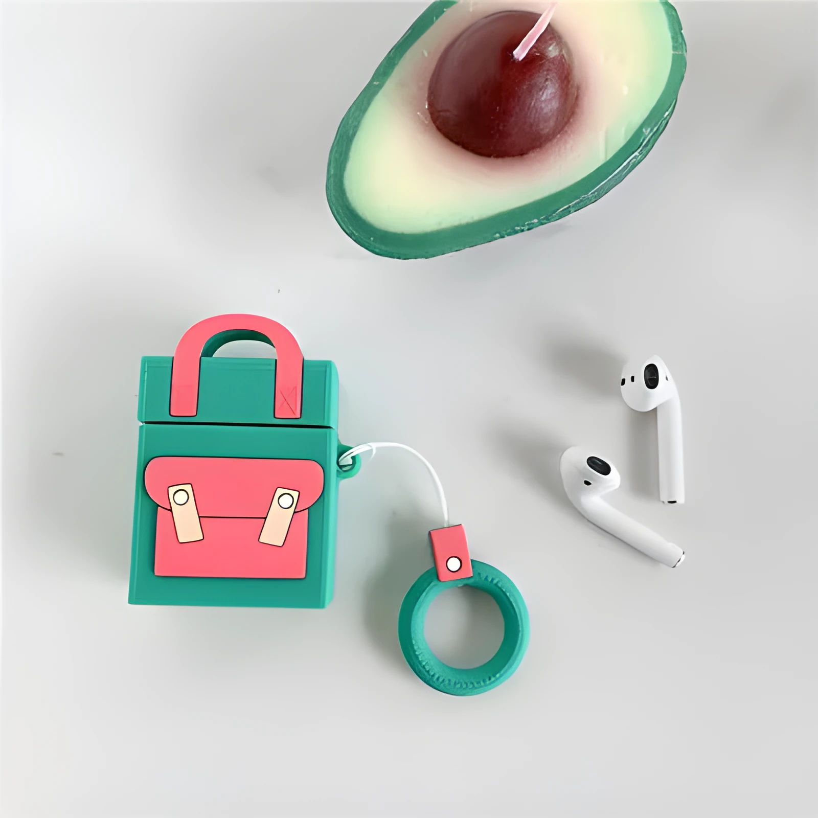 Silicone protective sleeve for AirPods 1 and 2 charging case with hanging ring, available in dark blue, green, purple, and yellow colours