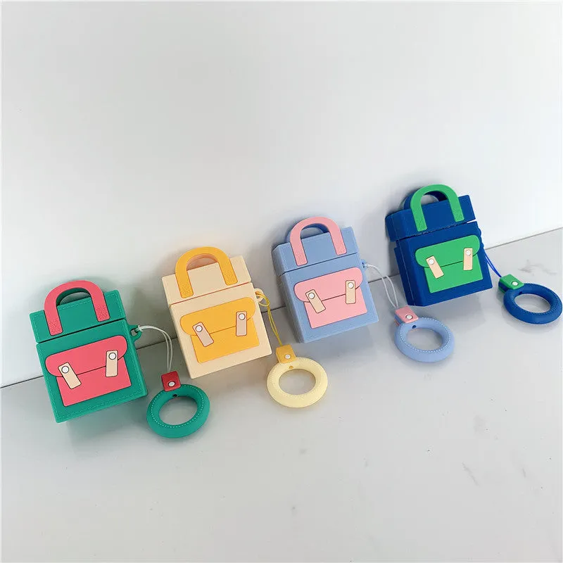 Silicone protective sleeve for AirPods 1 and 2 charging case with hanging ring, available in dark blue, green, purple, and yellow colours