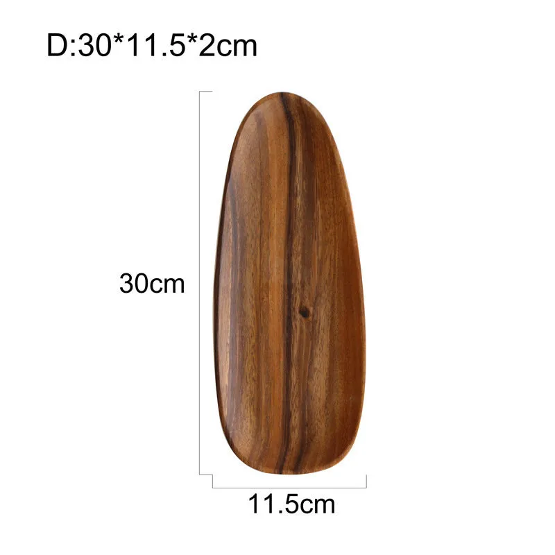 Acacia Japanese snack plate hand-polished natural wood with visible grain and mineral lines on a flat surface